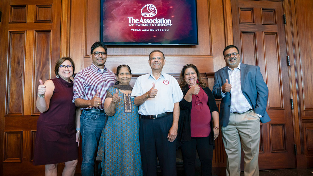 Dilipkumar Patel ’66, center, celebrates receiving his Aggie ring with family and friends at the Clayton W. Williams, Jr. Alumni Center.