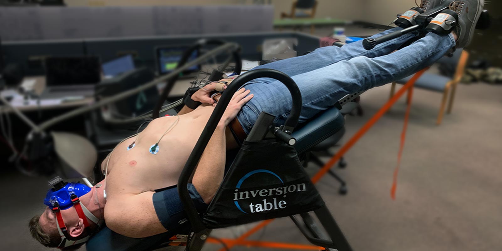 Male student strapped into an inversion table for study.