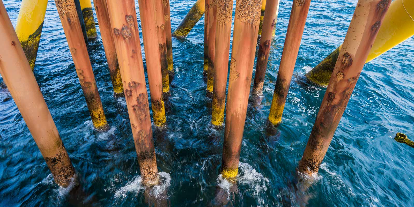Metal poles that have been corroded by the ocean.