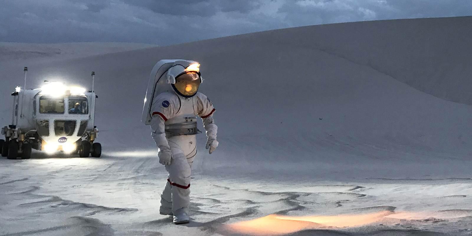 Graphic of an astronaut exploring the surface of another planet.