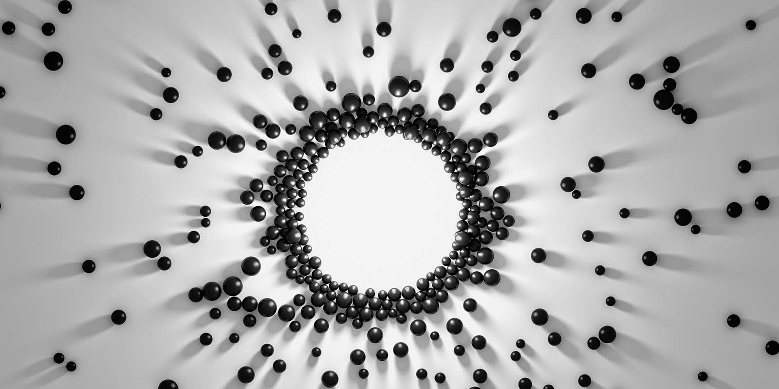 An abstract photo composed of small, spherical pellets arranged in a 2D circle against a white background.