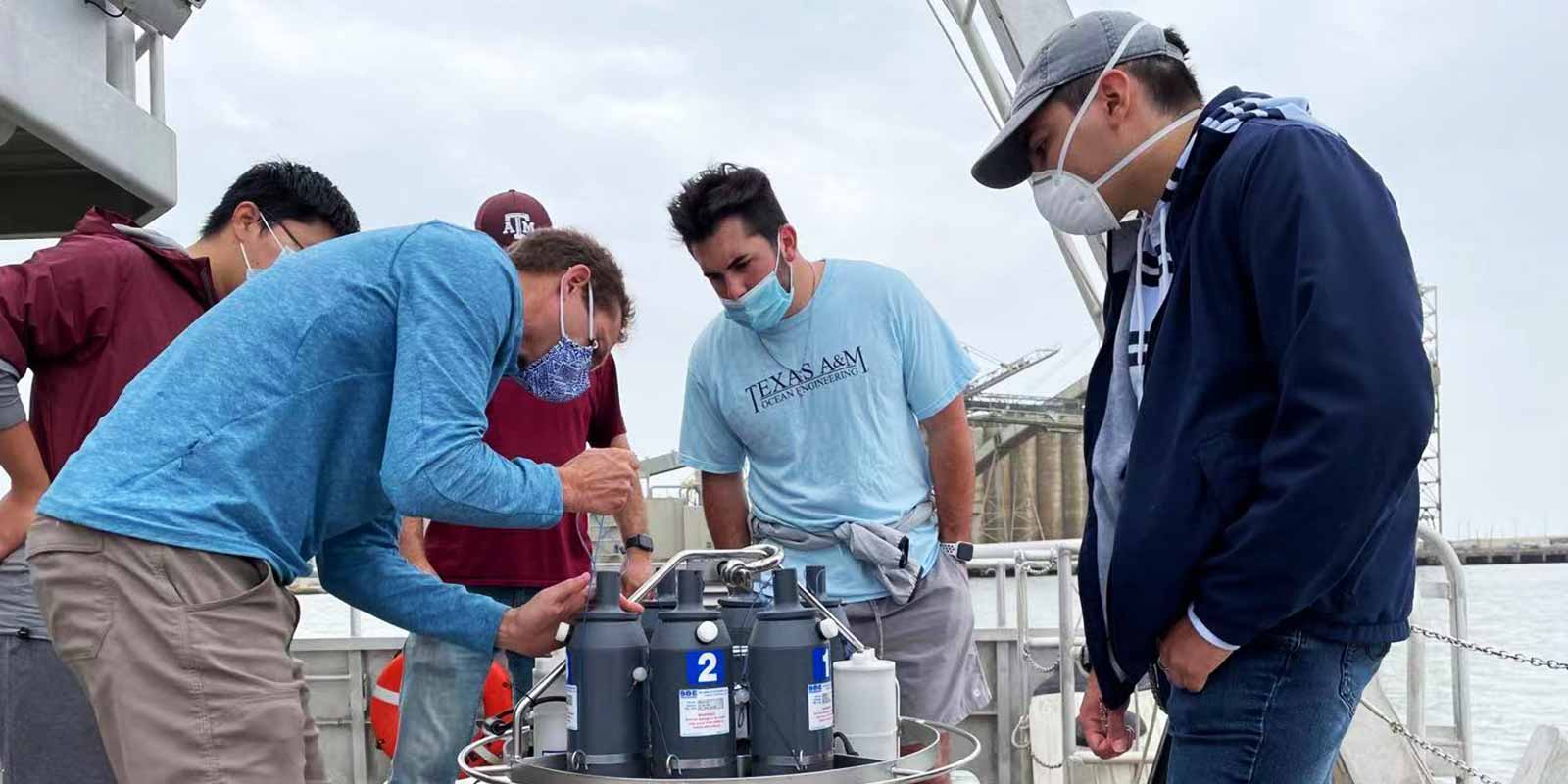 Students on Galveston campus performing a field experiment on a boat.